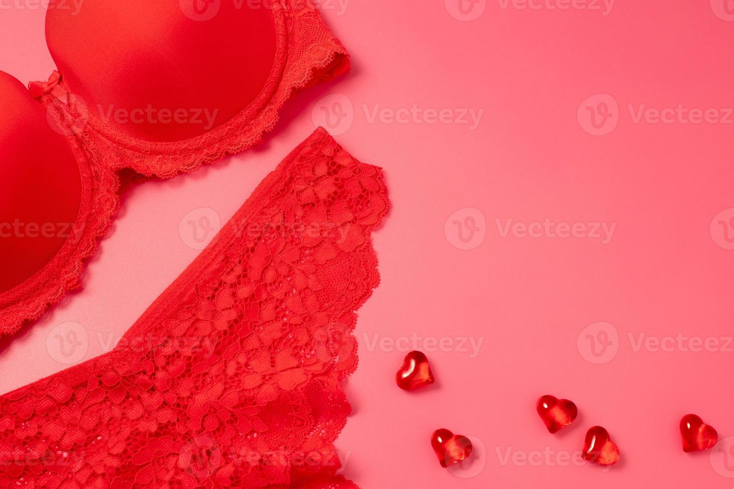 Valentine's Day background with beautiful female lacy panties, bra and hearts. Sexy underwear. Free space for text, copy space. Postcard, greeting card design. Love, celebration concept. photo