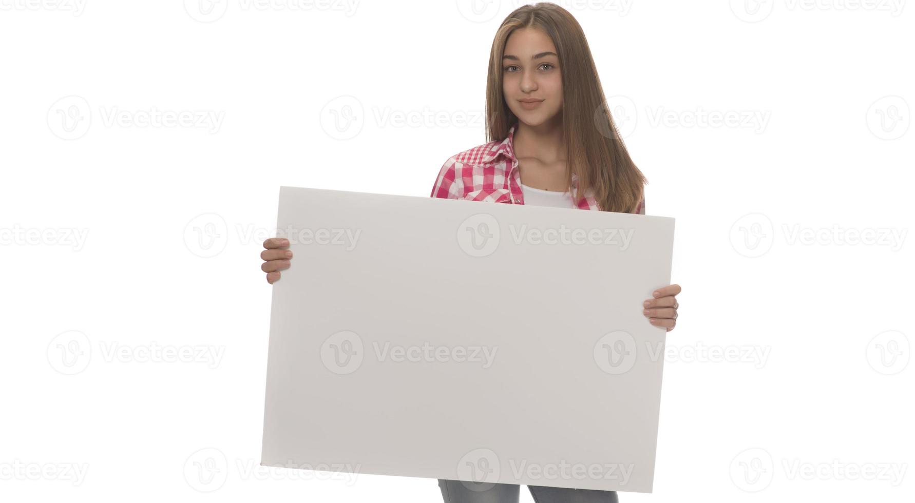 young smiling woman holding a blank sheet of paper for advertising photo