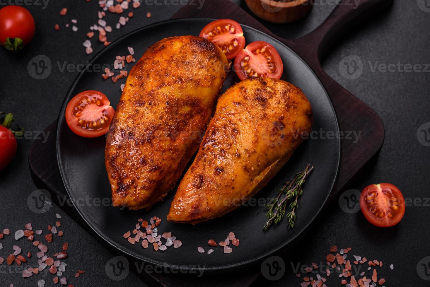 Delicious grilled chicken fillet with spices and herbs photo