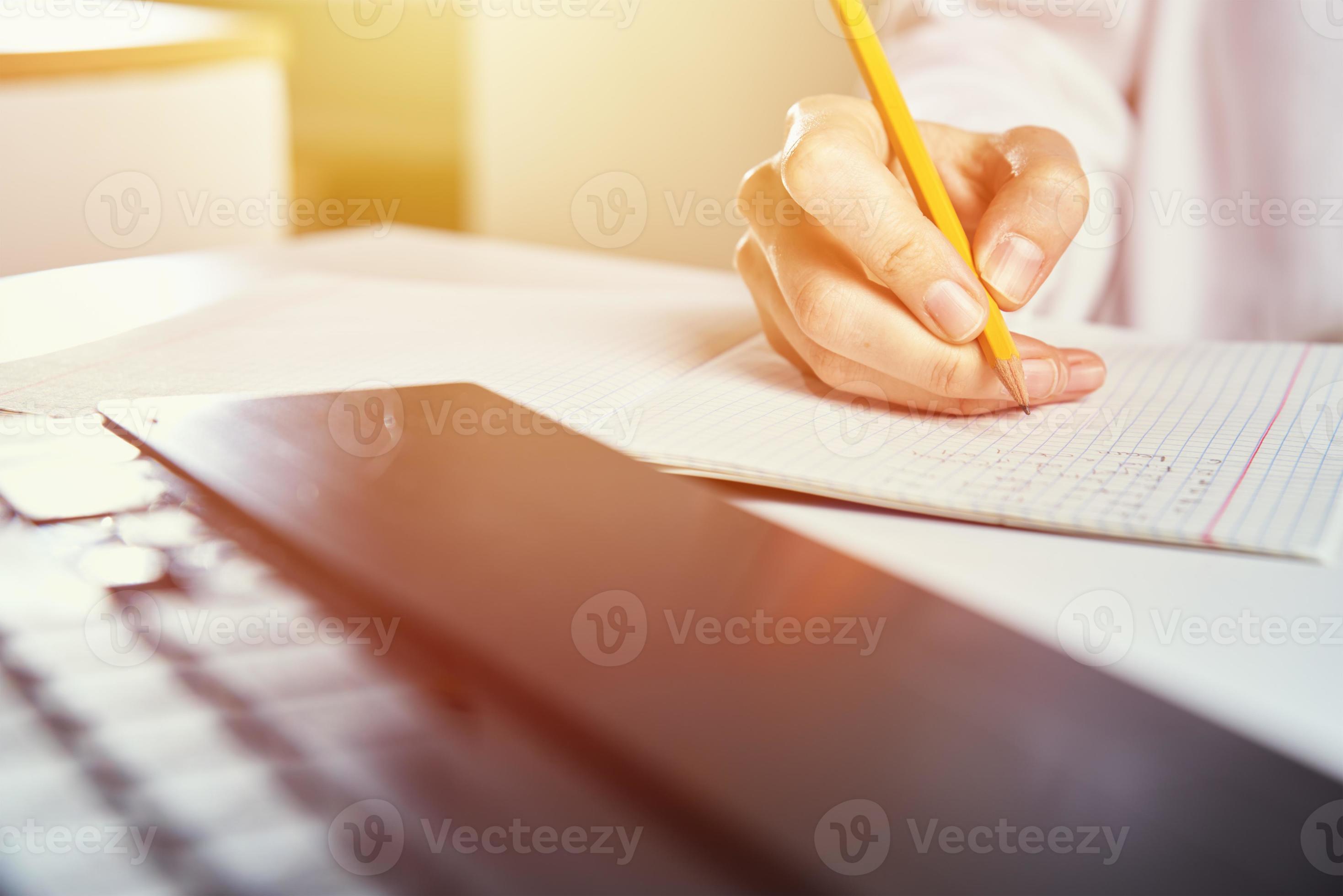 Woman makes notes in notebook and using laptop for study 16629145 Stock ...