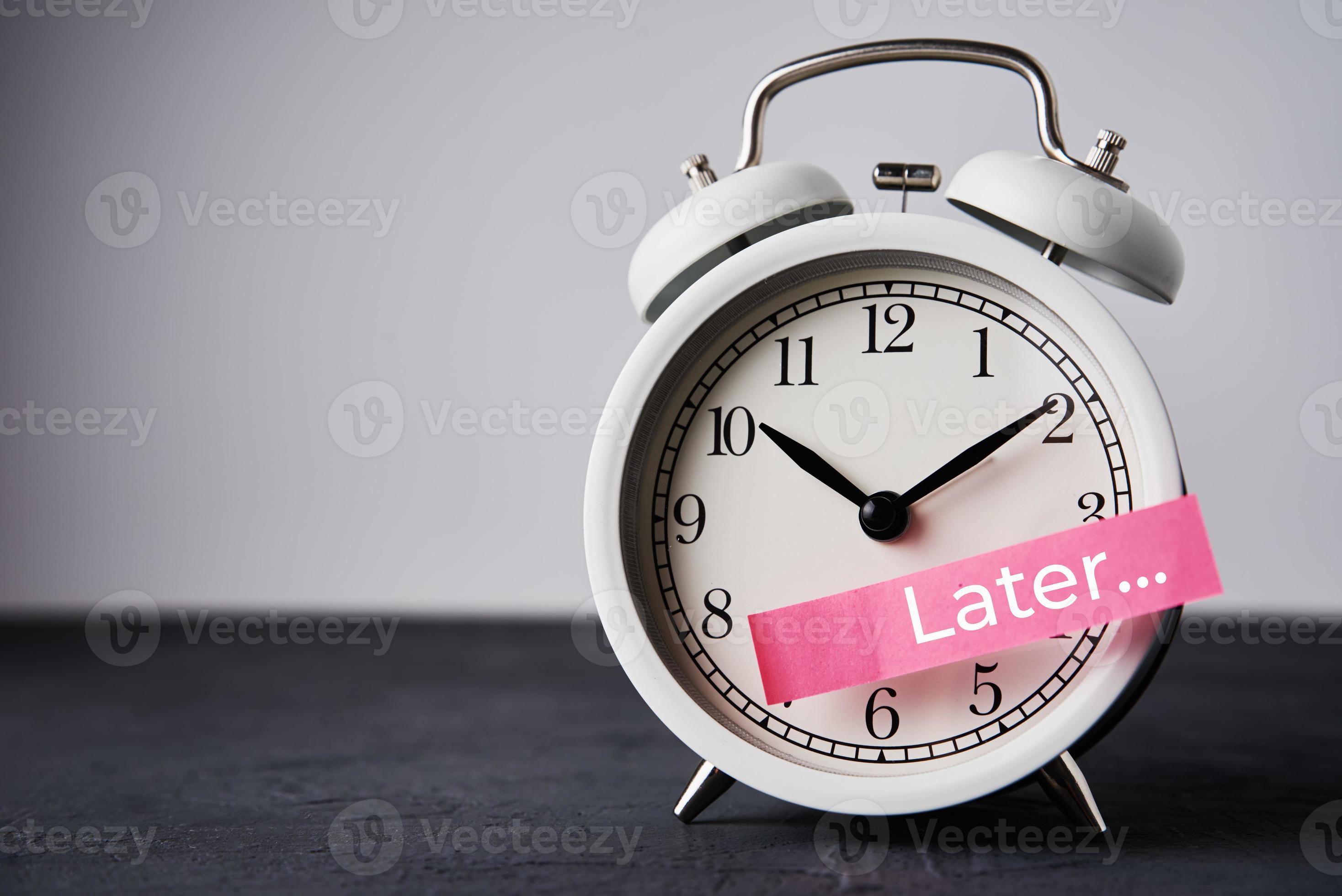 Sticky note with word later on white alarm clock. Urgency time 16629211 Stock Photo at Vecteezy