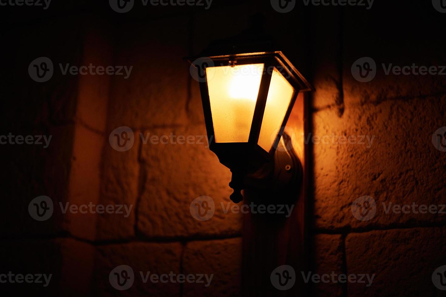 Vintage lantern at night. Old lantern in city street photo
