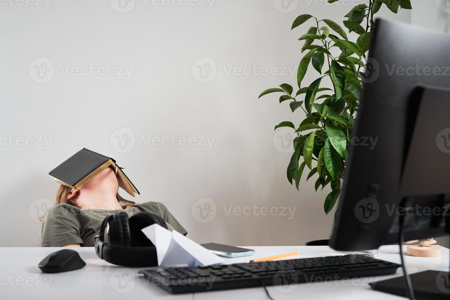 Bored woman sleep at workplace. Remote work at home photo