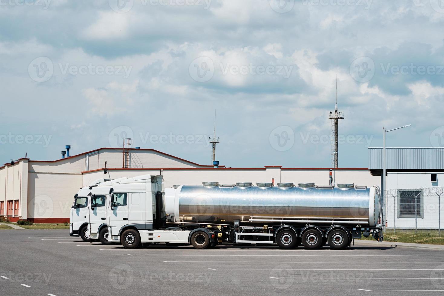 Trucks with tank trailer on parking lot photo