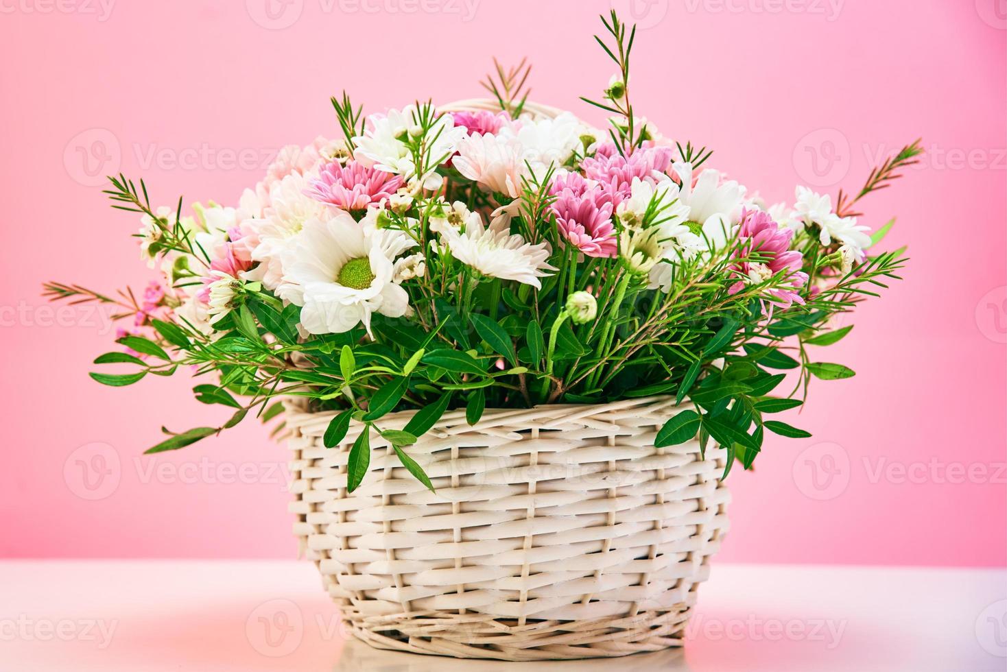 Bunch of fresh summer flowers on the pink background photo