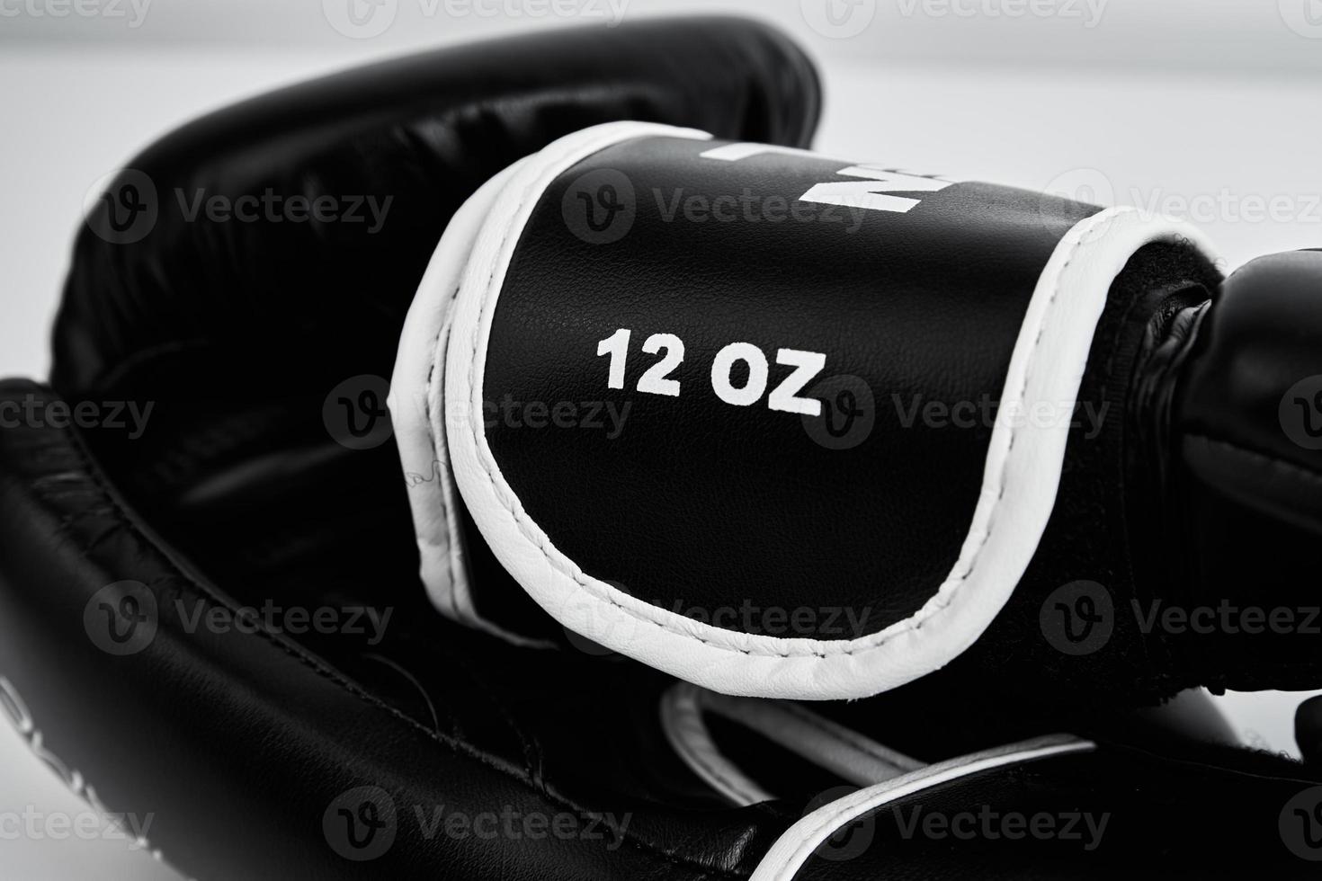 Pair of black boxing gloves on white background, closeup photo