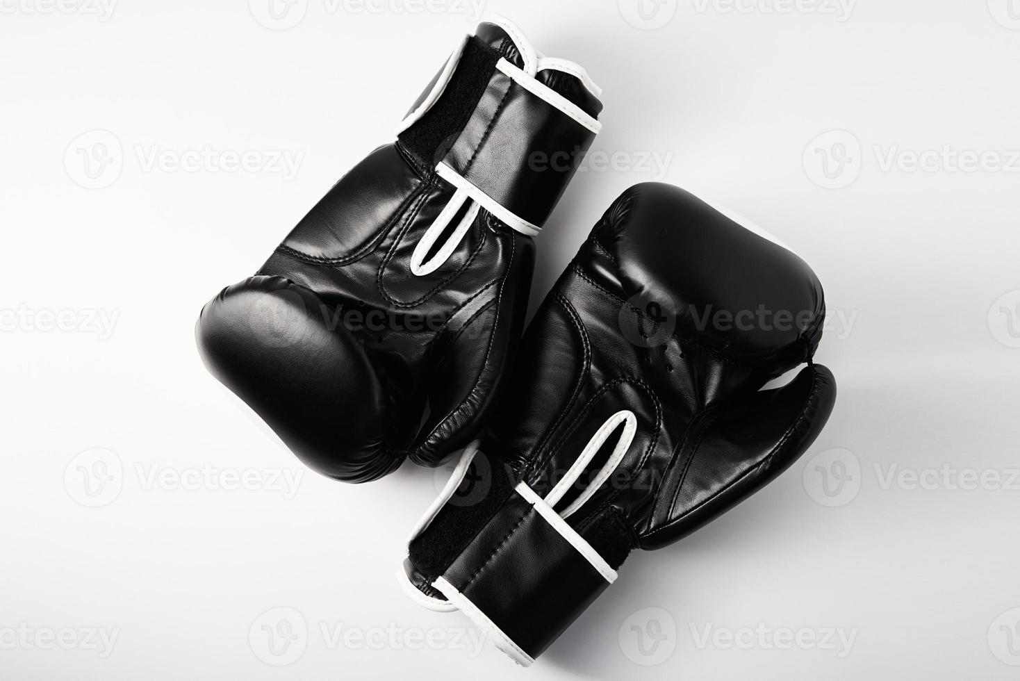 Pair of black boxing gloves on white background, closeup photo