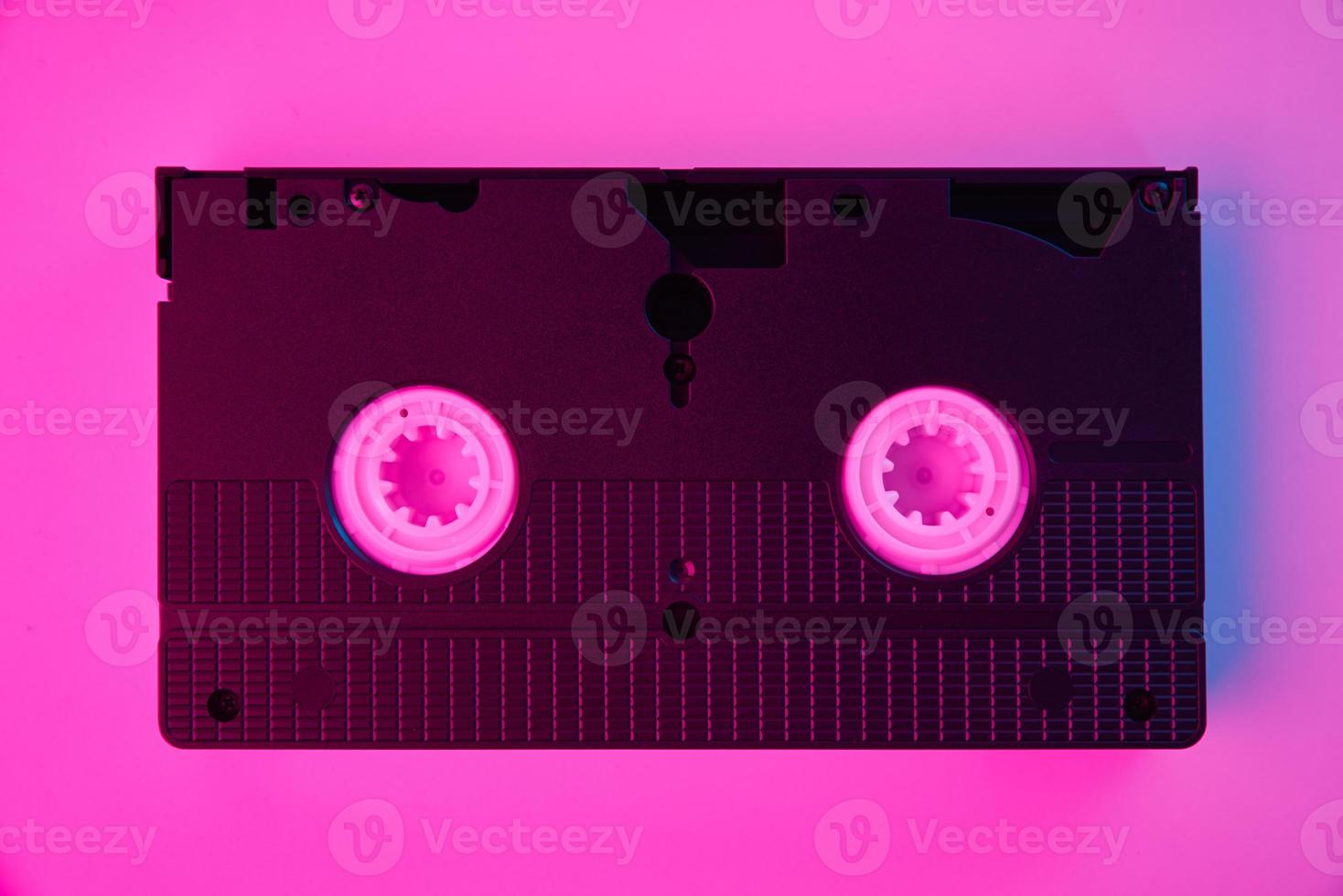 Video cassete on the color background. Retro vhs cassette tape photo