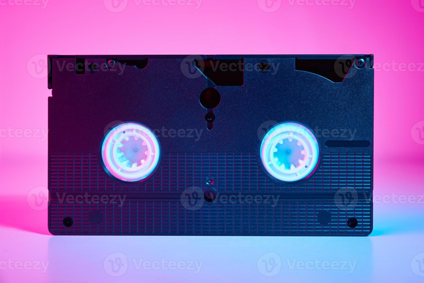 Video cassete on the color background. Retro vhs cassette tape photo