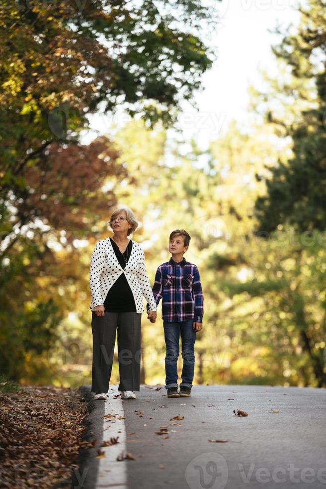 Grandmother and grand son enjoying sunny holiday together outdoors photo