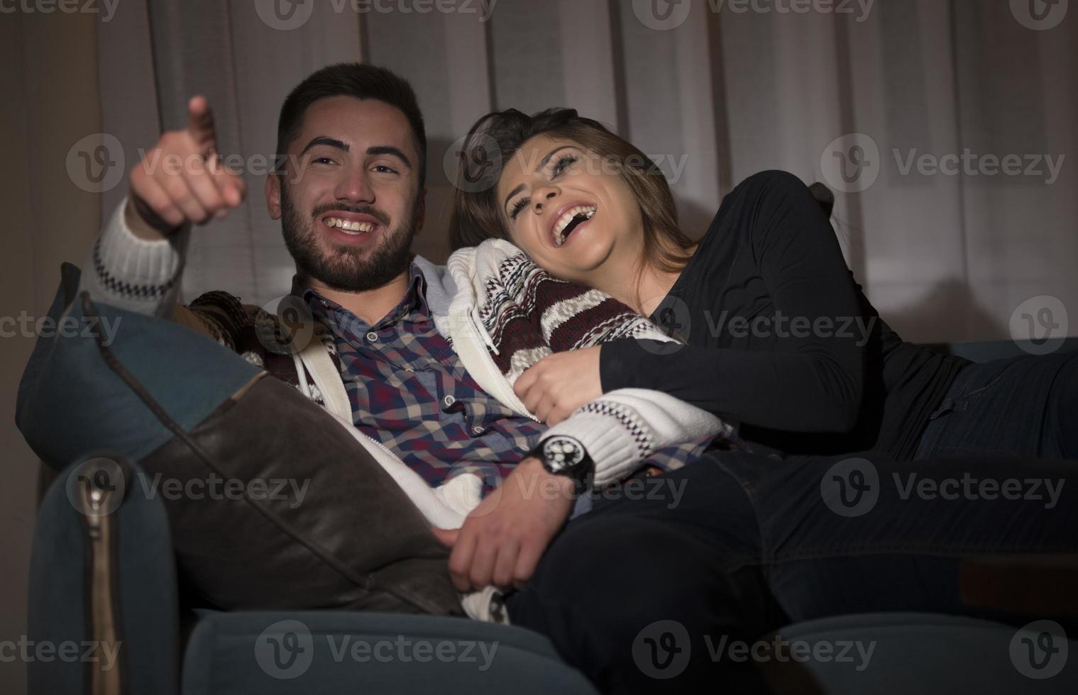 Couple having fun watching soccer game on tv photo