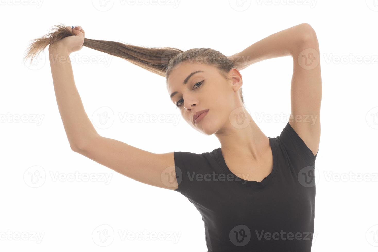 Young attractive smiling woman holding her strong hair photo