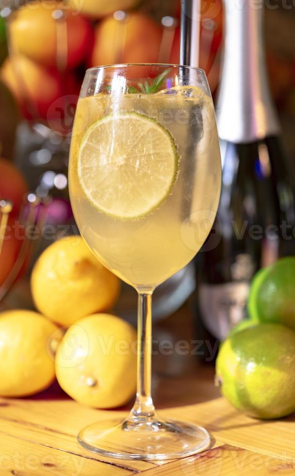 Cold cocktail with lime, lemon, tonic, vodka and ice photo