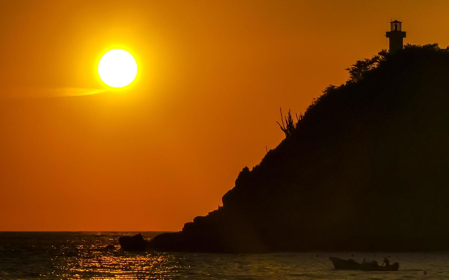 Colorful golden sunset big wave and beach Puerto Escondido Mexico. photo