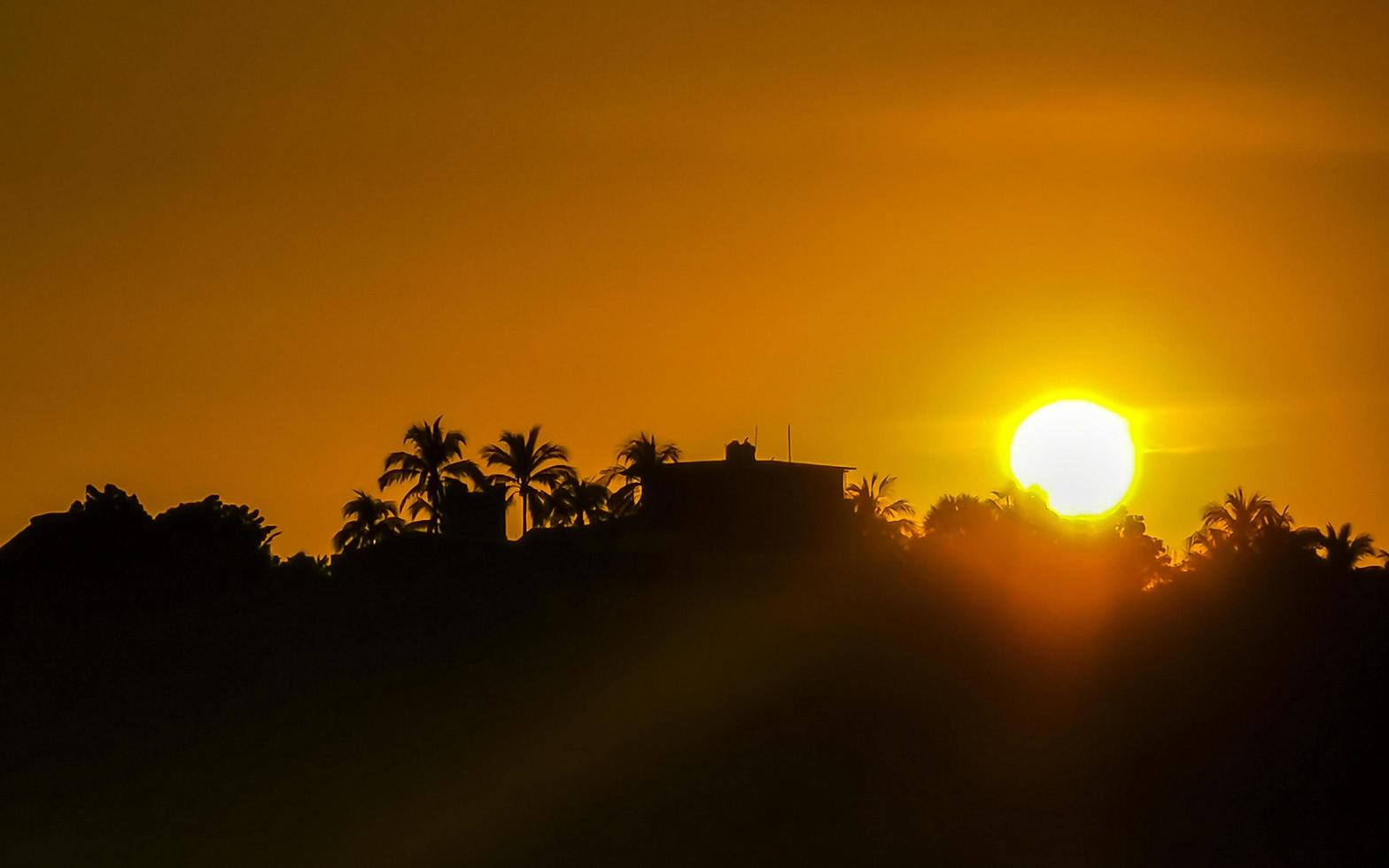 Colorful golden sunset big wave and beach Puerto Escondido Mexico. photo