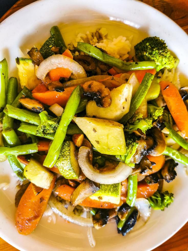 Fried rice and vegetables on white plate Puerto Escondido Mexico. photo