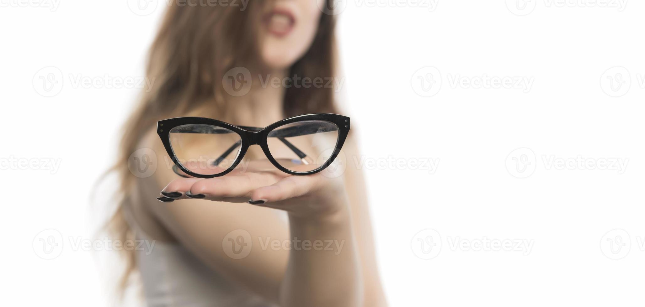 beautiful young woman holding eye glasses photo