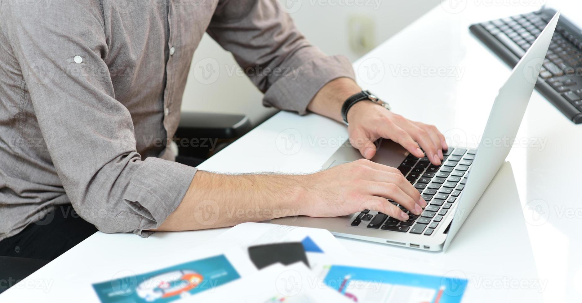 hands typing on the laptop on the business desk. business concept photo