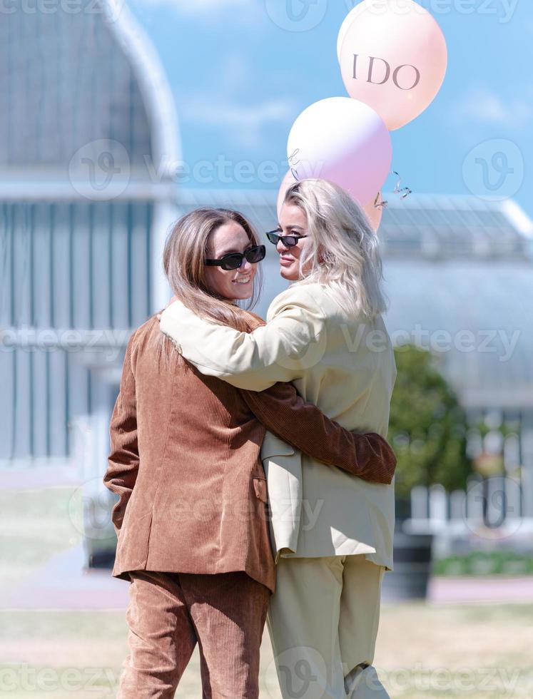 A couple of gay woman smiling and kissing. Same sex young married female couple in their daily routine showing some affection LGBT photo