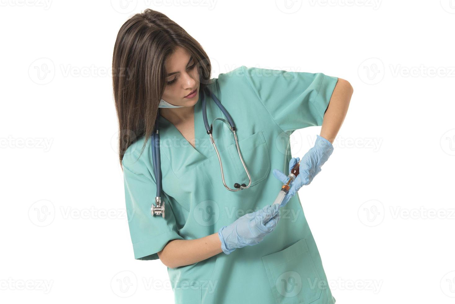 Woman Nurse with protective workwear holding Vaccine and syringe photo