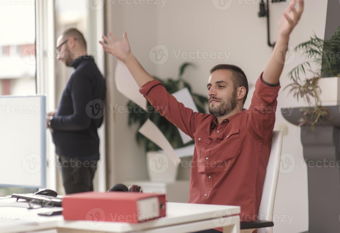 Two partnerships developing programming and coding technologies working on laptop and analyzing together. photo