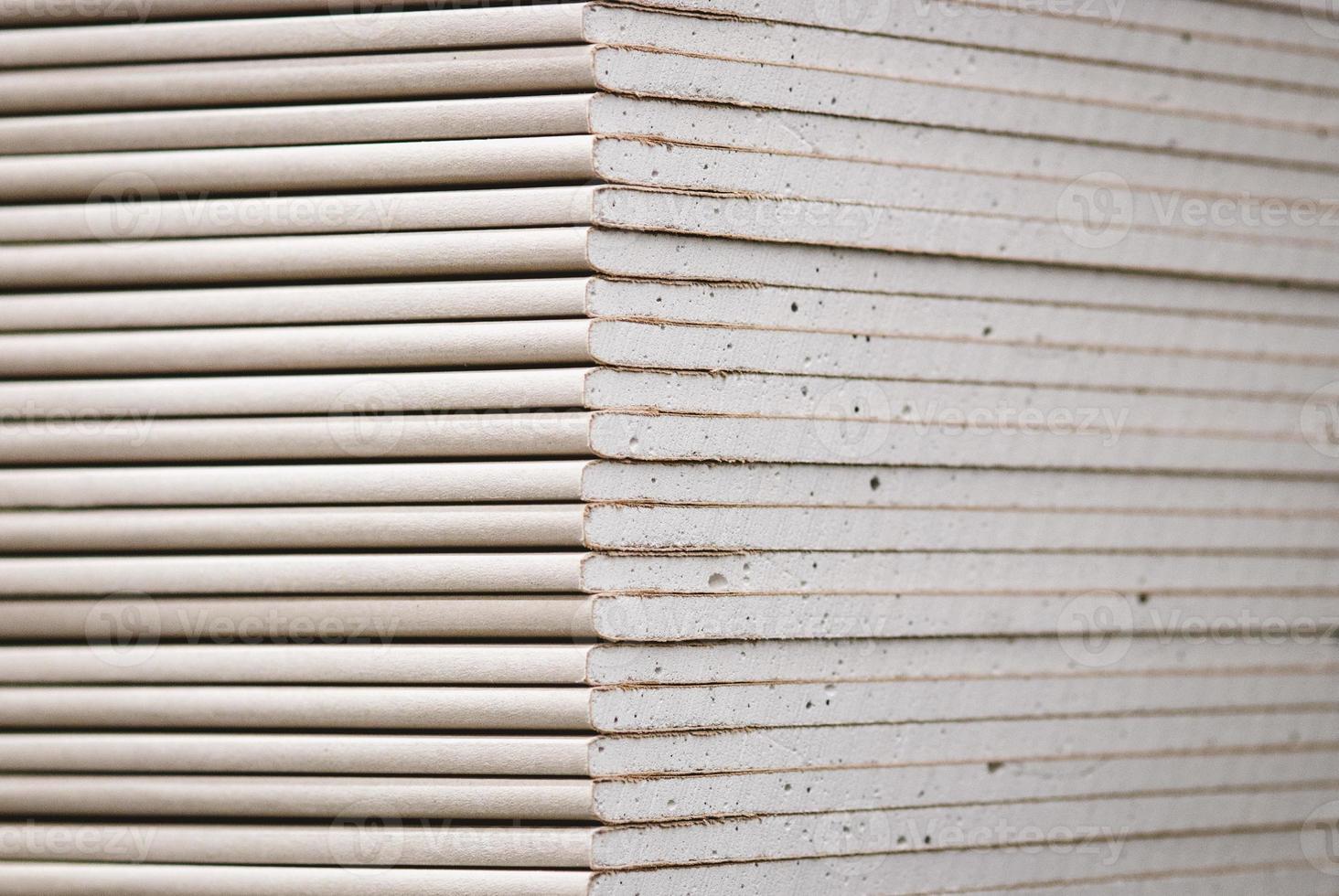Drywall standard gypsum panels, wallboards plasterboard stacked in hardware store closeup photo