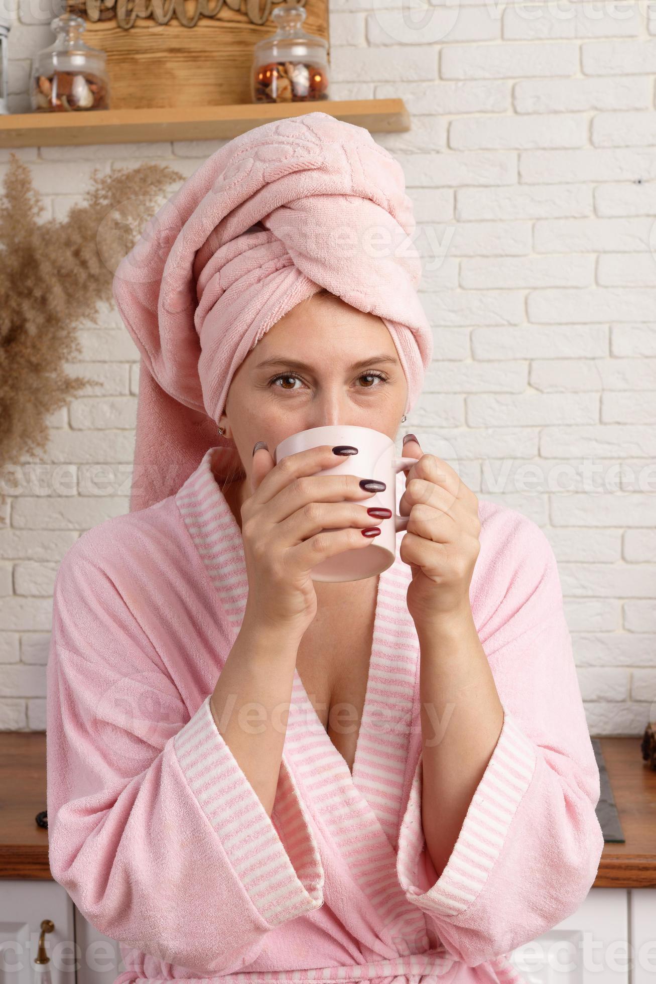 woman in bathrobe after shower drinks coffee for breakfast at home. 16642045 Stock Photo at Vecteezy