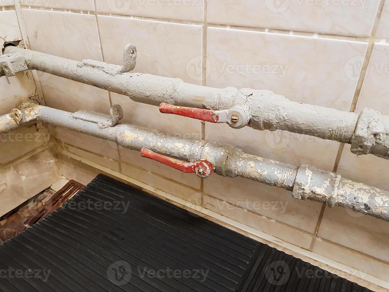 Rusty pipe in the shower room. Garbage can clog the pipe in the