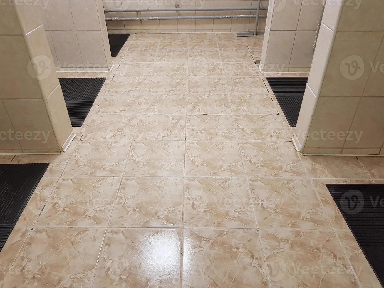 Floor in public shower, old interior in gym. photo