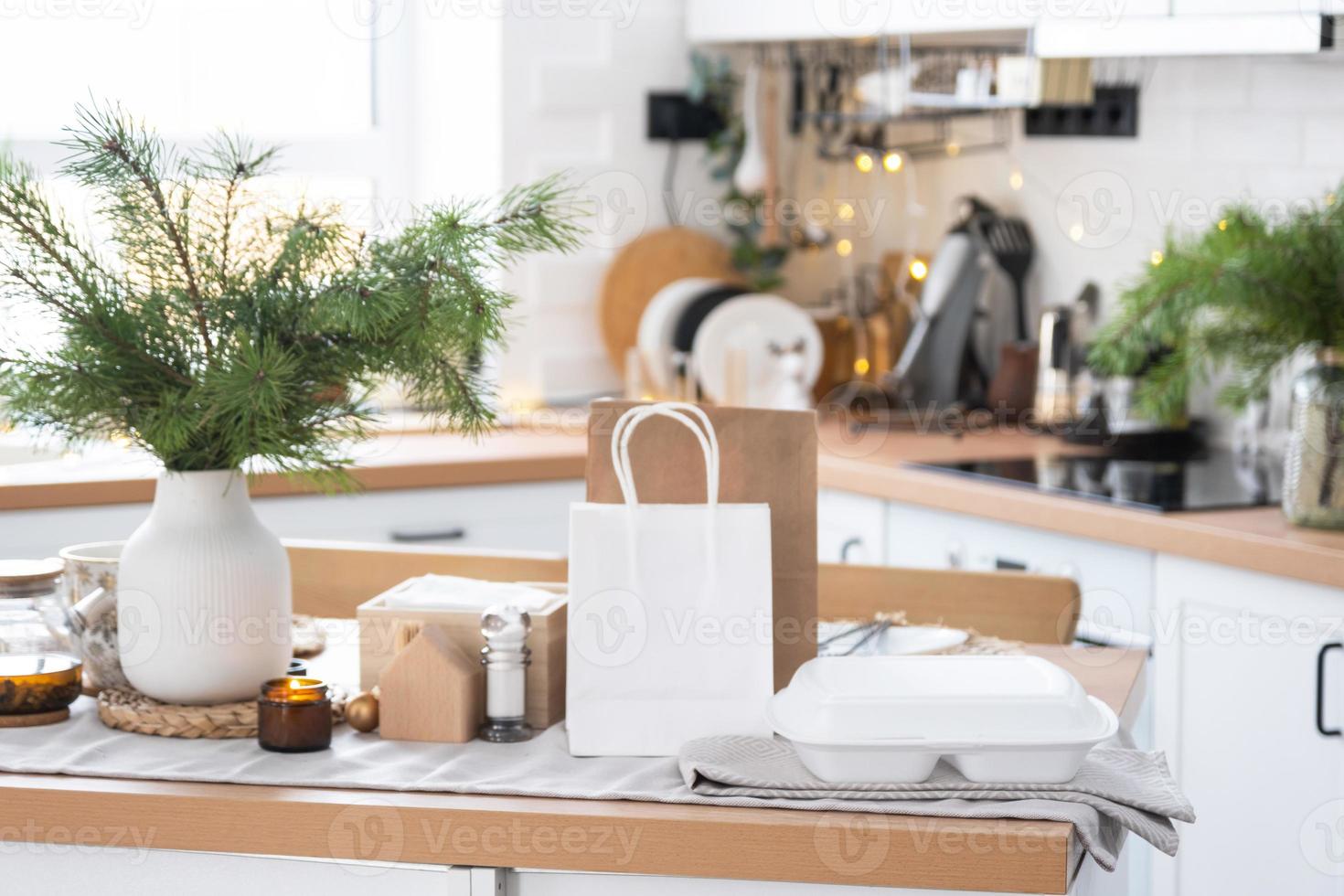 Food delivery service containers on table in white kitchen, festively served for celebration of Christmas and new year.  Saving time, hot order, disposable plastic box, craft package. mock up photo