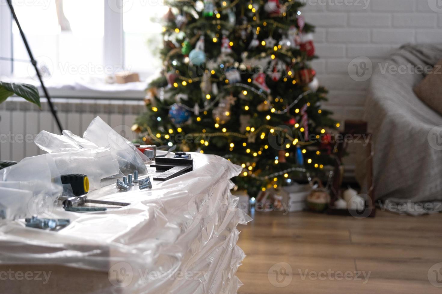 Building materials with tools for home repair on the background of a Christmas tree - decorative repairs and construction for the new year photo