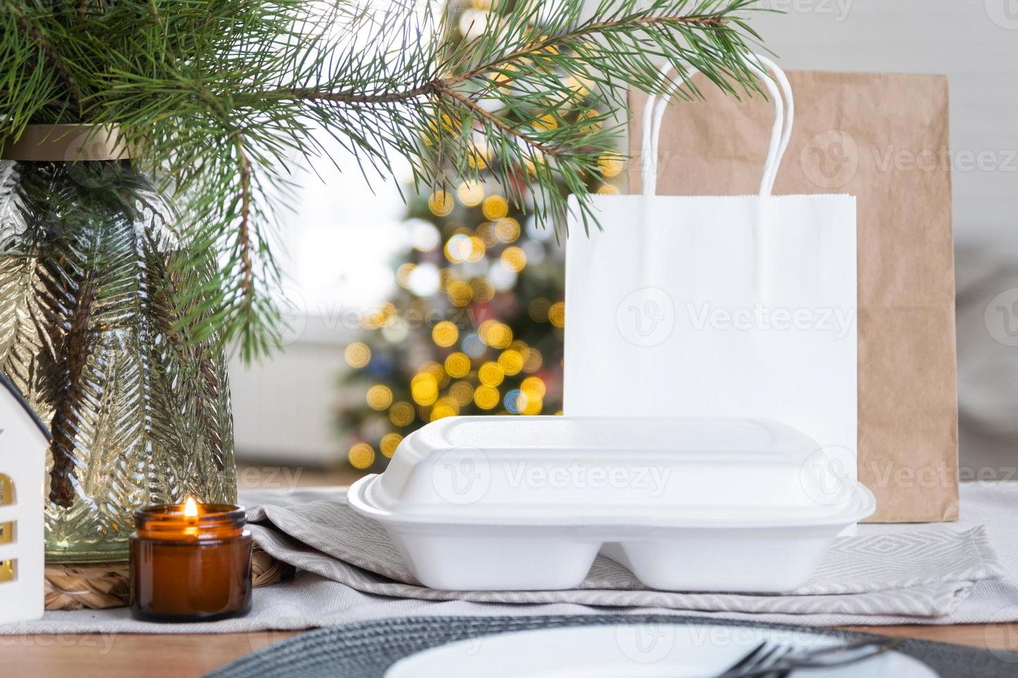Food delivery service containers on table in white kitchen, festively