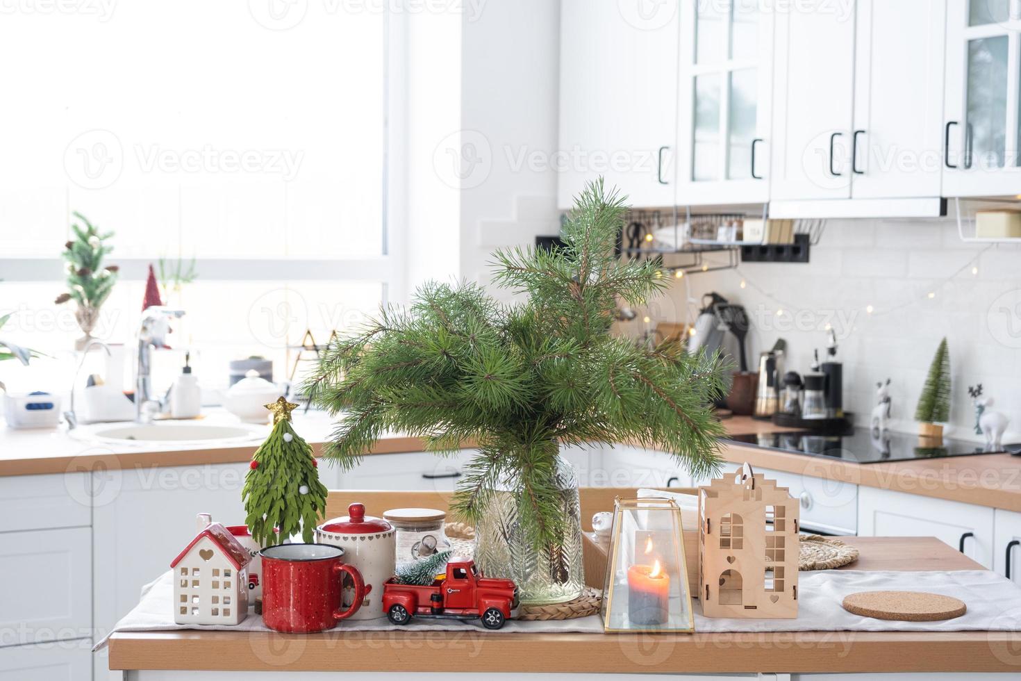 Festive Christmas decor in white kitchen, festive breakfast, white scandi interior. The figure of a cozy house ion the set table. New Year, mood, cozy home. Copy space photo