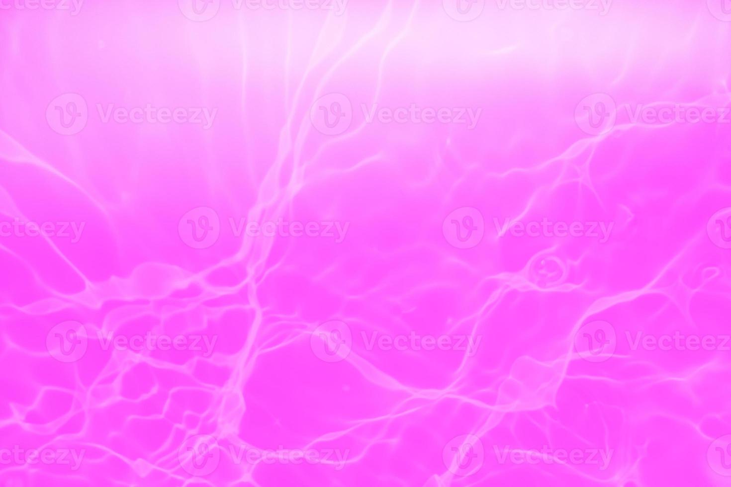 Defocus blurred transparent purple colored clear calm water surface texture with splashes and bubbles. Trendy abstract nature background. Water waves in sunlight with copy space. Pink water drop shine photo
