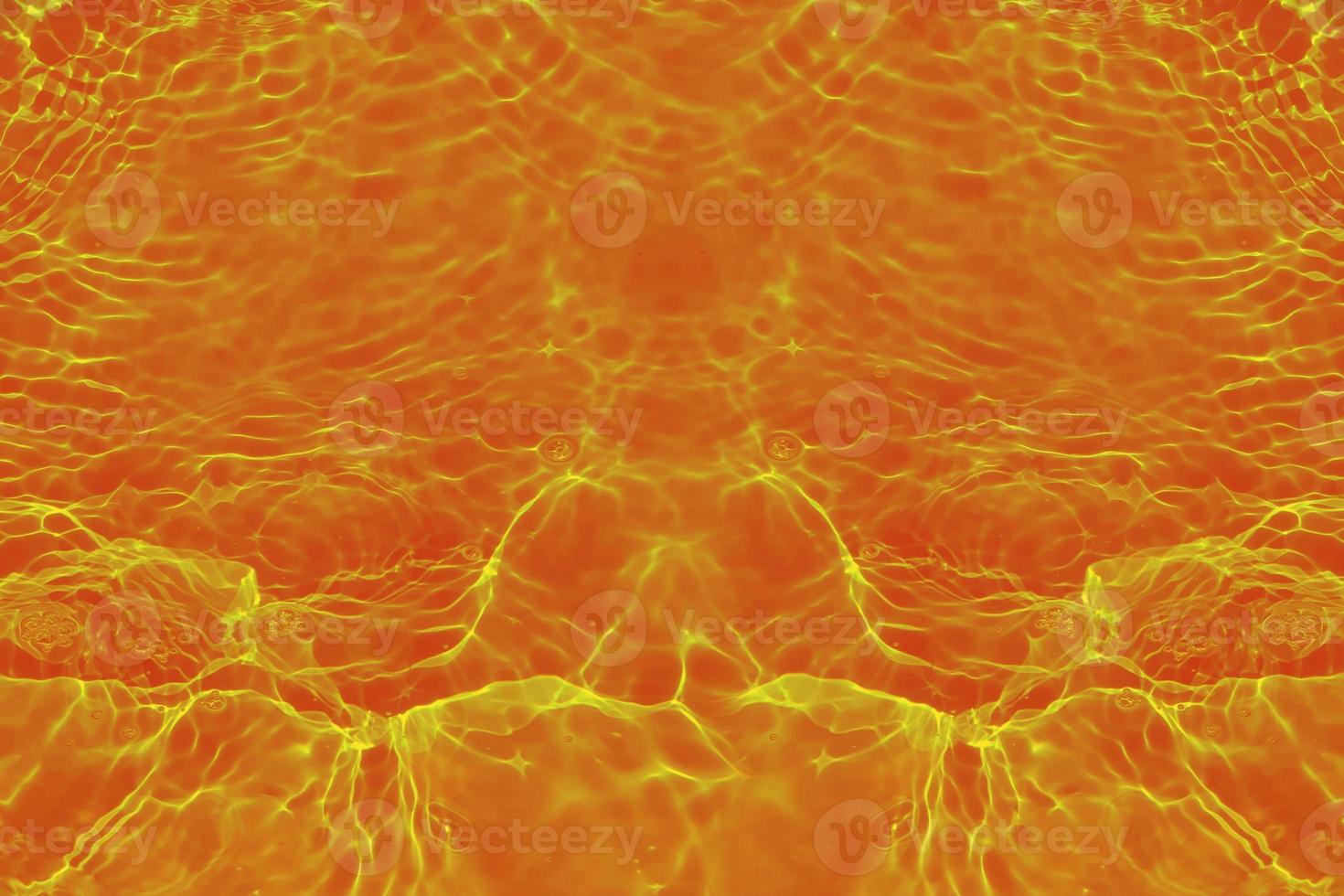 Defocus blurred transparent orange colored clear calm water surface texture with splashes and bubbles. Trendy abstract nature background. Water waves in sunlight with copy space. Red watercolor shine photo