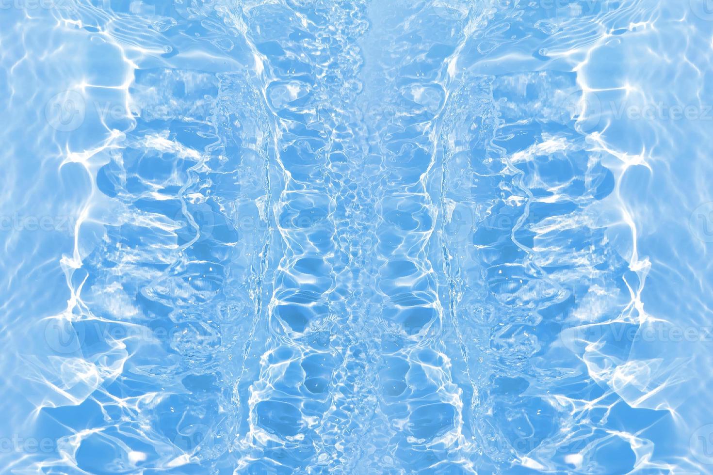 Defocus blurred transparent blue colored clear calm water surface texture with splashes and bubbles. Trendy abstract nature background. Water waves in sunlight with caustics. Blue water shinning photo