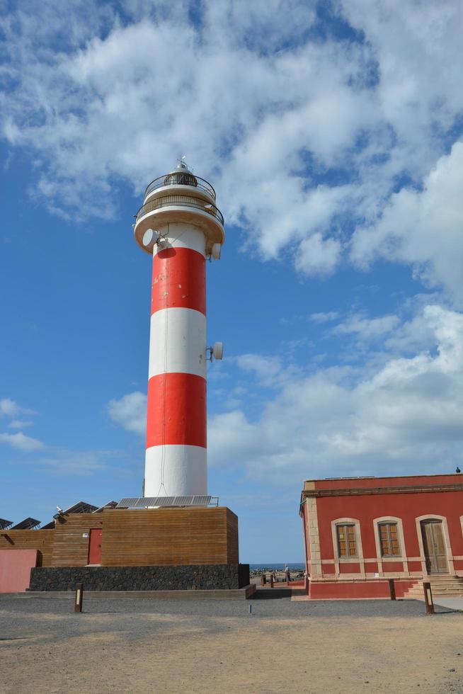 Beautiful lighthouse and fishing museum in the wonderful bay filled with volcanic stones in Bajo Ballena. El Cotillo La Oliva Fuerteventura Canary Islands. photo