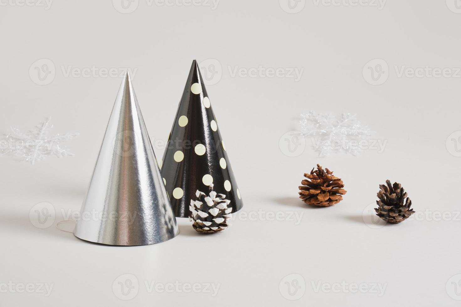 paper homemade party hat and christmas decor on a gray background, postcard copy space for the new year photo