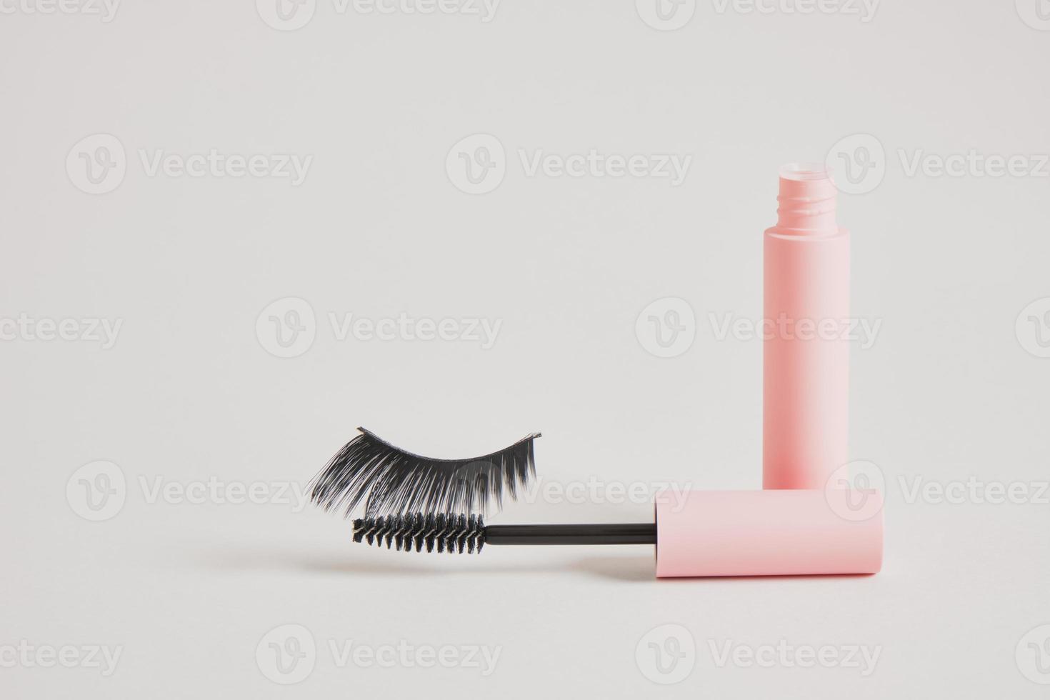 eyelashes makeup. Mascara and false eyelashes on gray background top view copy space photo