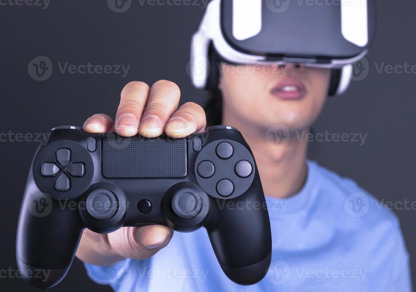 excited man in VR headset looking up and trying to touch objects in virtual reality photo