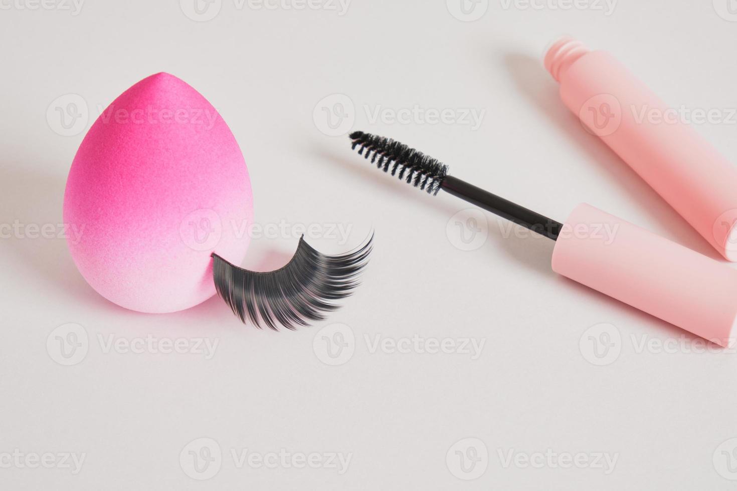 eyelashes makeup. Mascara and false eyelashes on gray background top view copy space photo