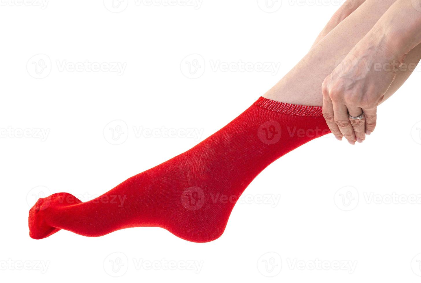 Girl putting on stockings at home. Beautiful female legs. photo