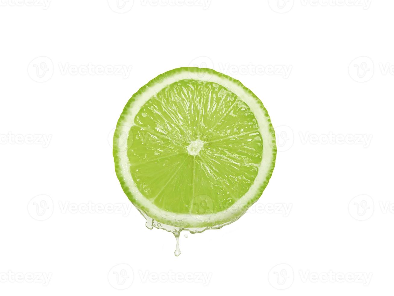 Lemon juice dripping from fruit on white background photo