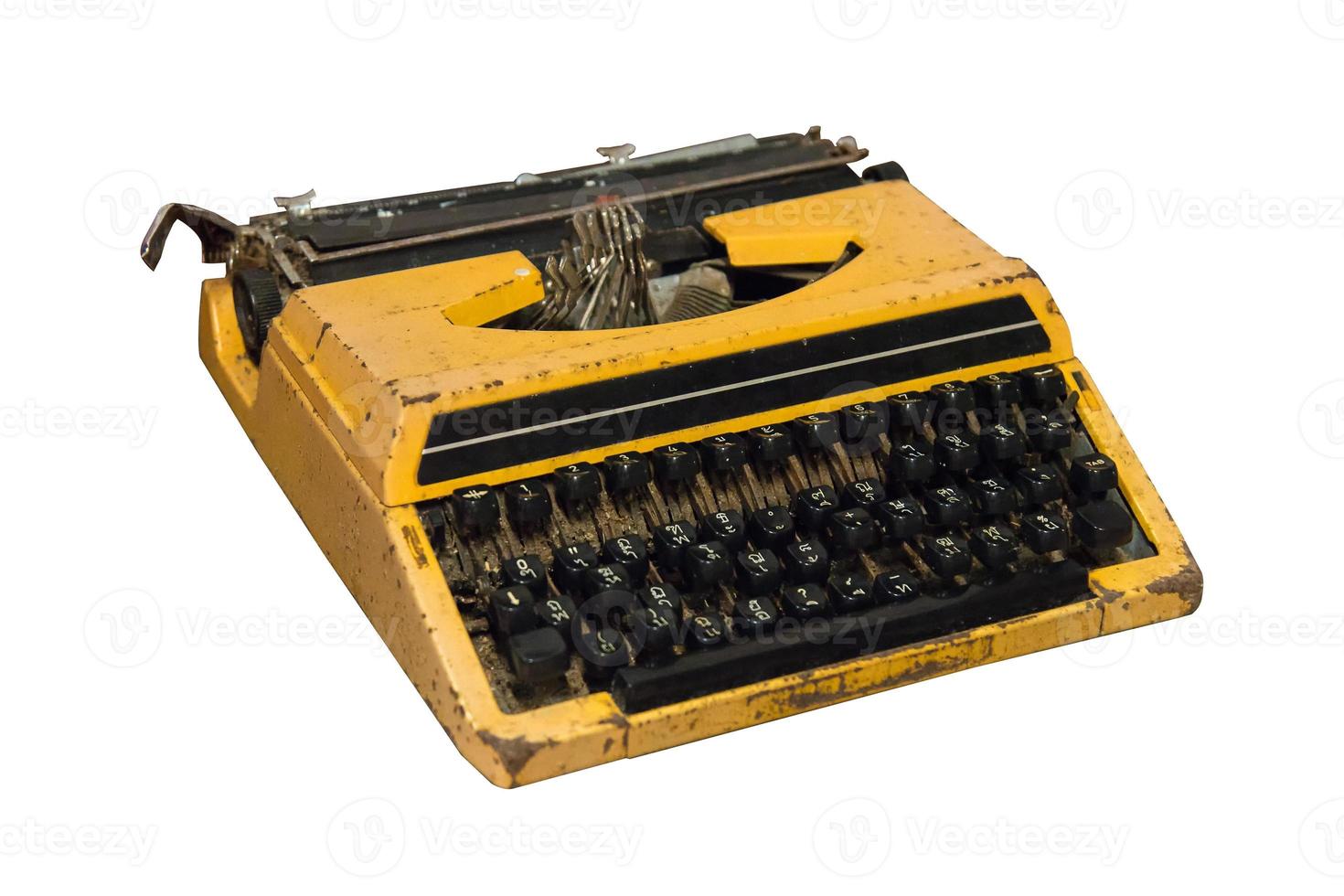 Rusty old vintage yellow typewriter isolated. photo