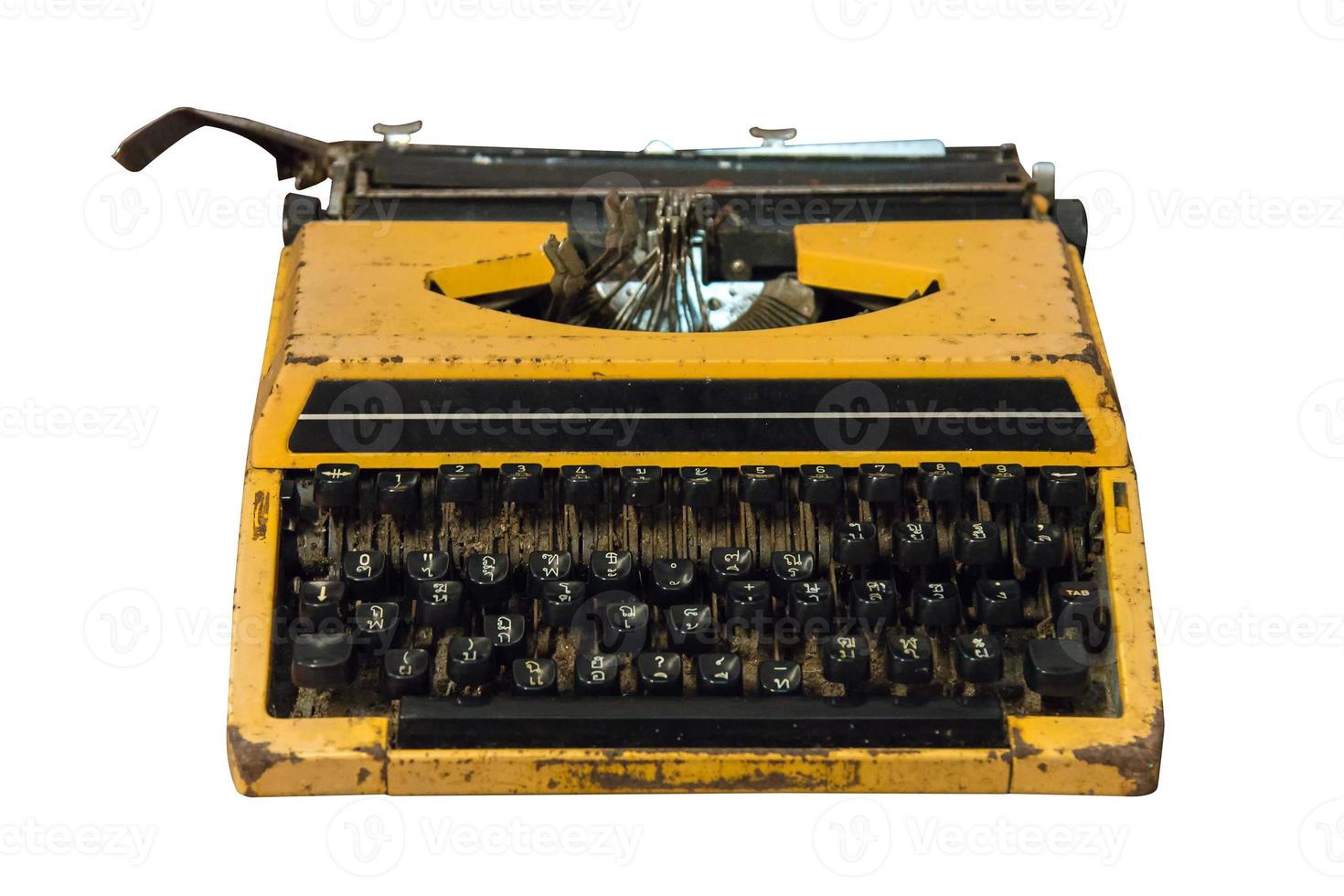 Rusty old vintage yellow typewriter isolated. photo