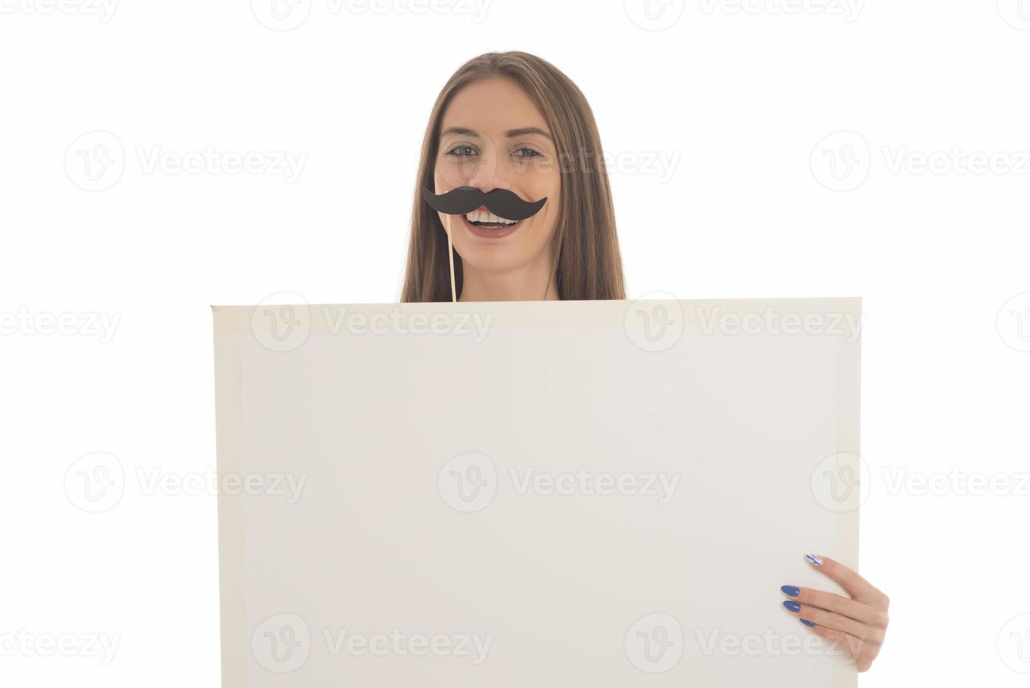 smiling girl holding blank sign board. studio portrait of young woman with sign card. isolated. photo