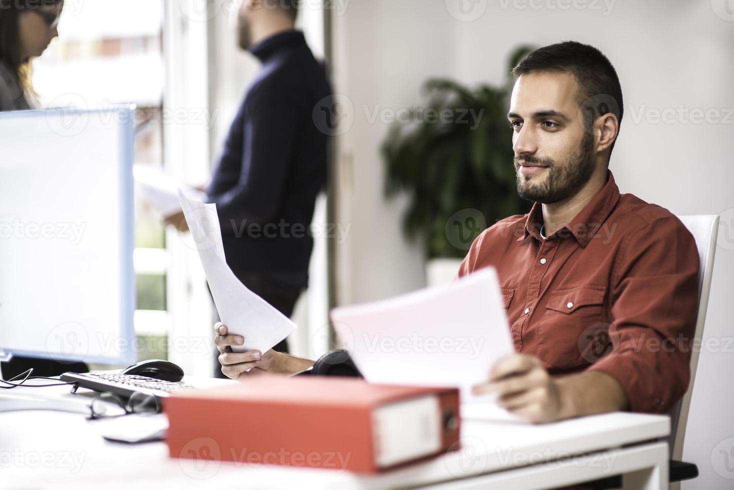 Two partnerships developing programming and coding technologies working on laptop and analyzing together. photo