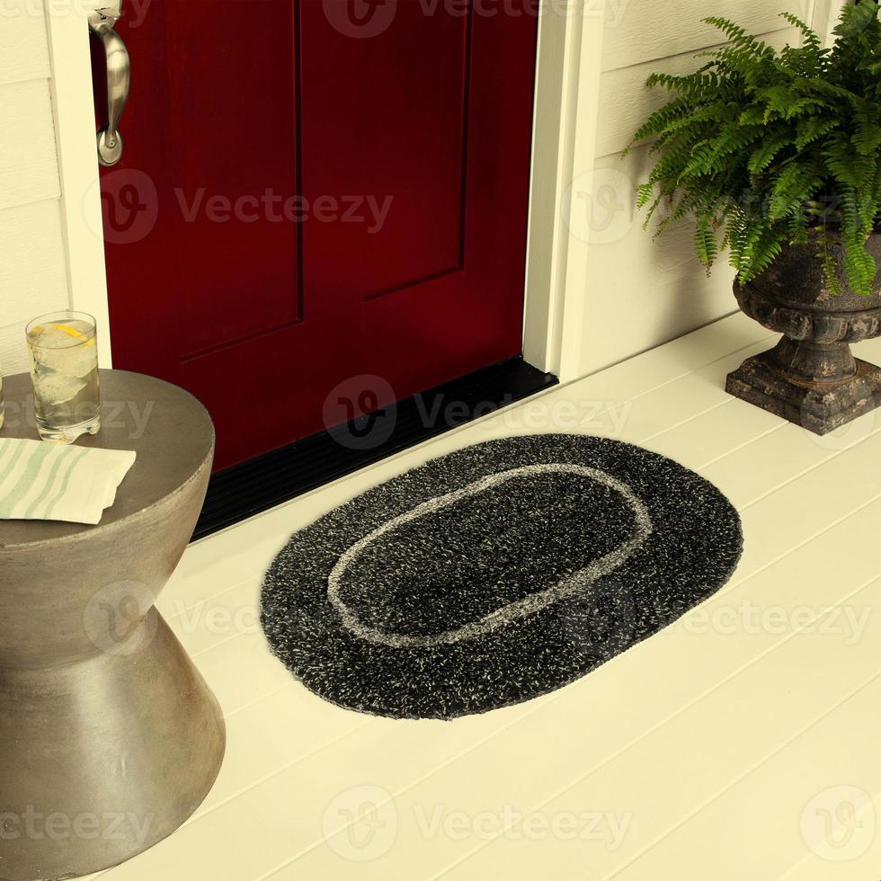 Designer Welcome Entry Doormat Placed on Floor Outside Entry Door with Plants and lemon ice drink photo