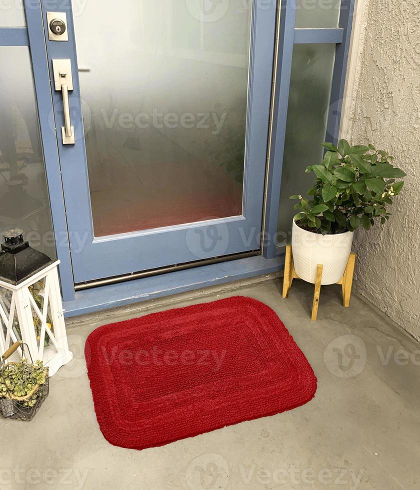 Designer Welcome Entry Doormat Placed Outside Entry Door with Plant and Lamp photo