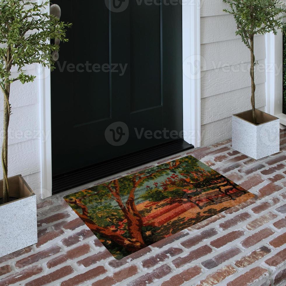 Designer Welcome Entry Doormat Placed on Solid Brick Floor Outside Entry Door with Plants photo